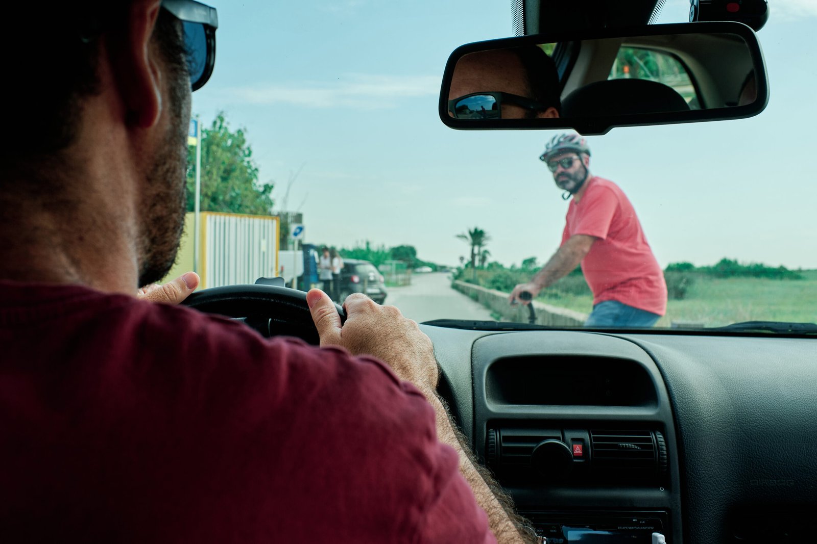 a electric scooter driver having a problem with a car driver