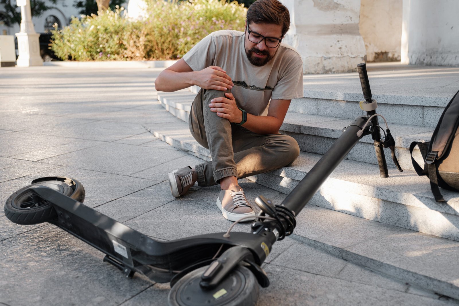 Young Man Accident With An Electric Scooter On Street. A man fell from a scooter on a city street.